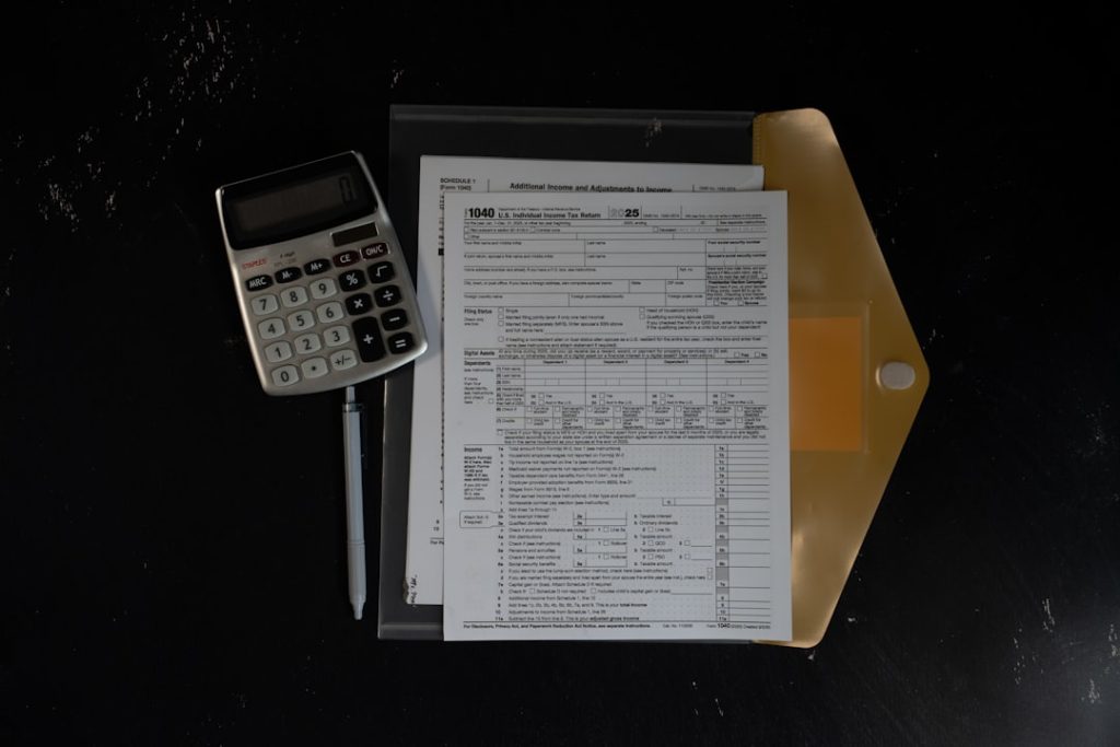 calculator-and-papers-in-a-folder-on-a-dark-surface-1qhmyhnen0